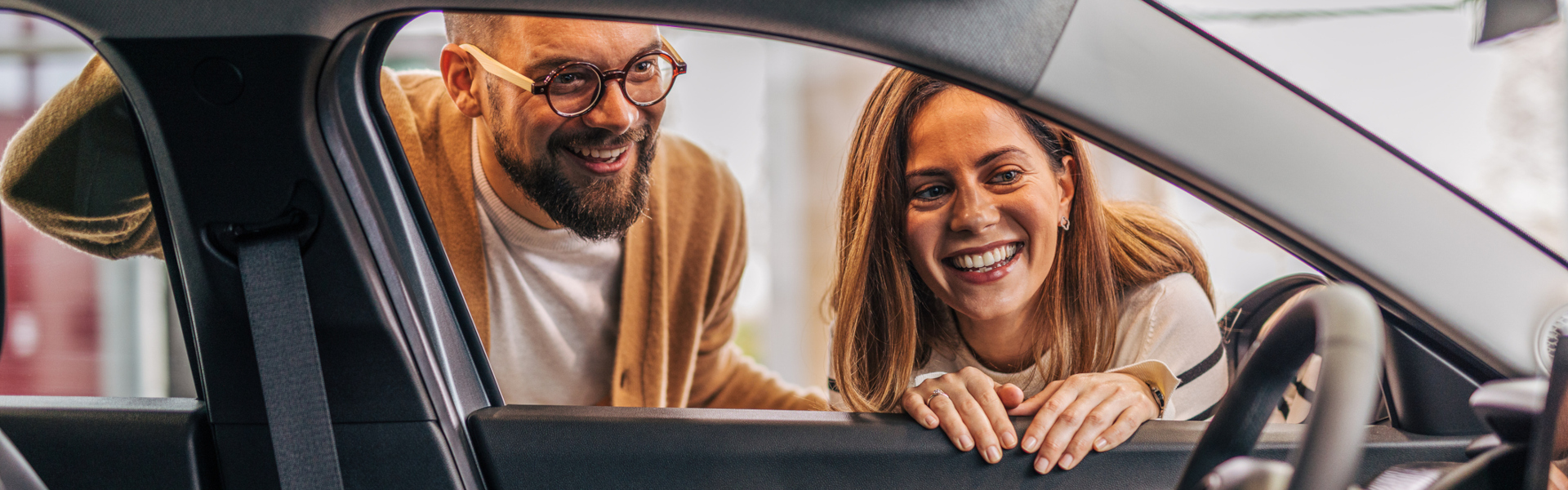 Customer examining a used car interior